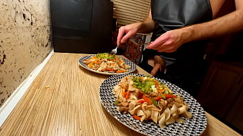 Super-sexy cooking. Bare fag chef is cooking rice noodle with chicken and vegetables