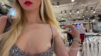 Super-cute doll in a jaw-dropping dress showcases globes in a public store.